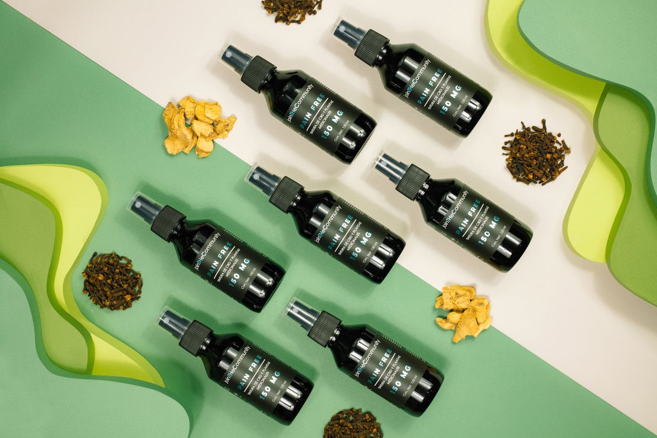 Top view of herbal skincare serum bottles on an abstract background with natural ingredients.